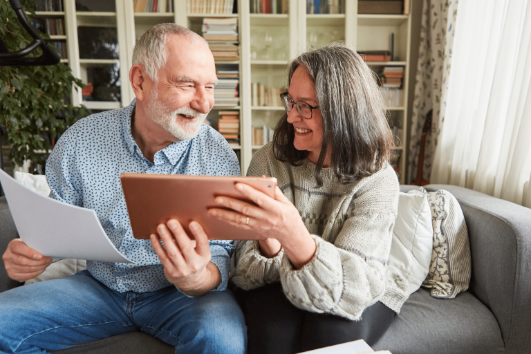 Elderly couple using a tablet to search for doctors online.